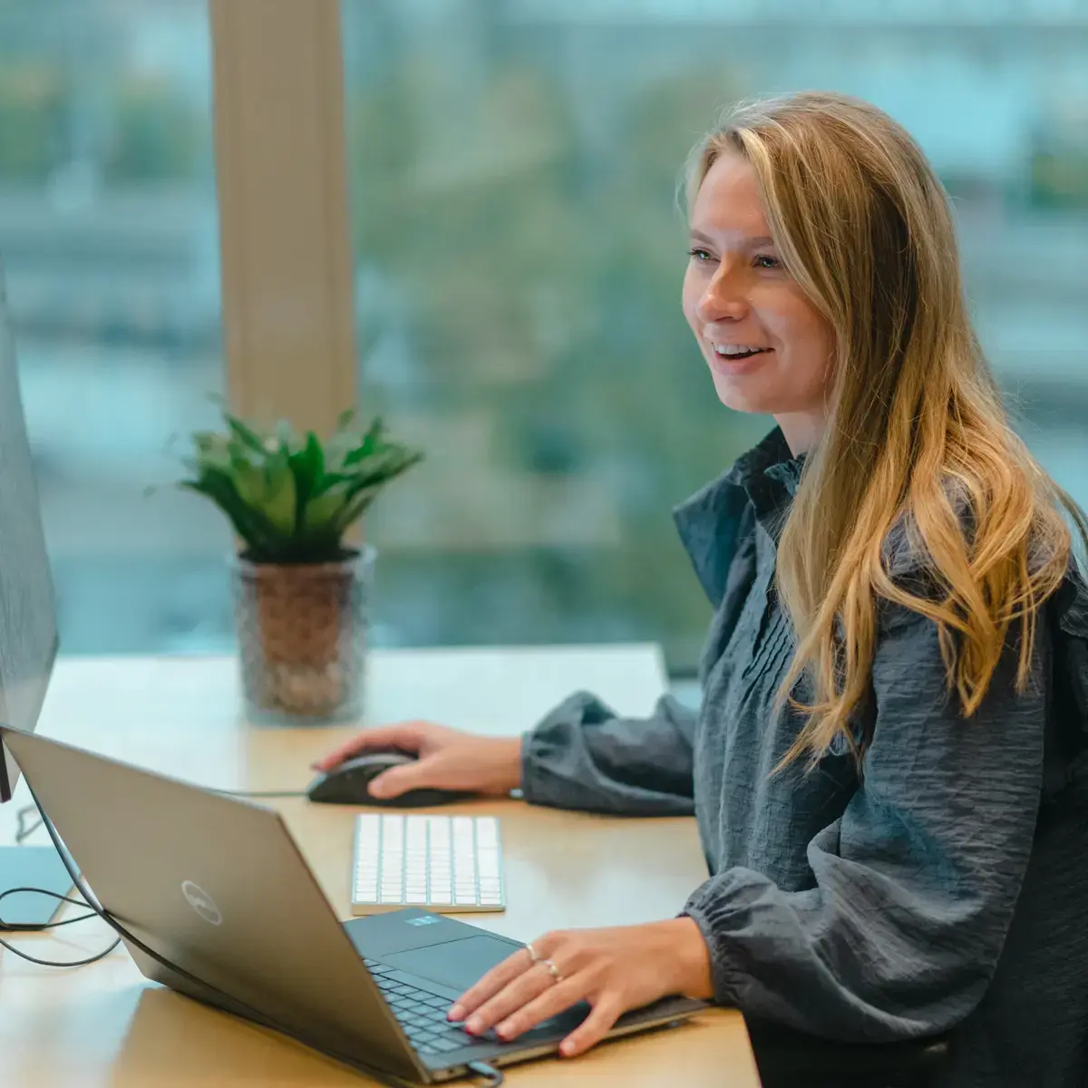 woman-sitting-at-a-table-with-a-laptop-1200x1200-01